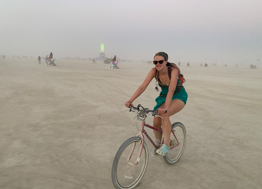 Anna at the Burning Man Festival on her Burner bike. She’s attended nine consecutive years (except COVID) and organizes a theme camp called Dome on the Range, which builds and operates an old western-style saloon.
