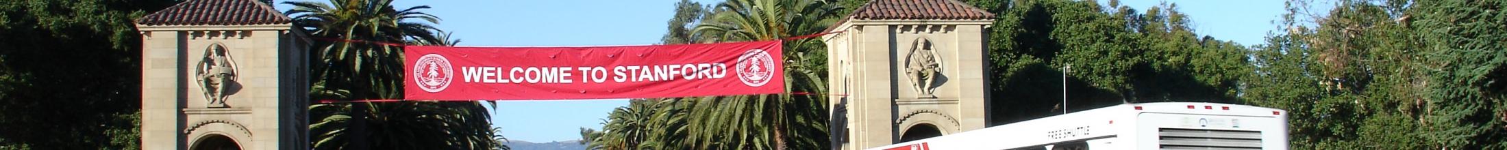 Marguerite bus on Palm Drive below "Welcome to Stanford" banner