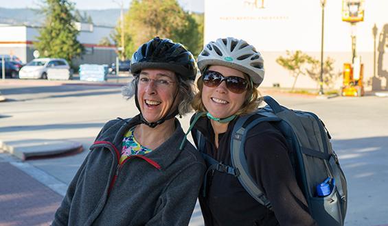 two bicyclists smiling