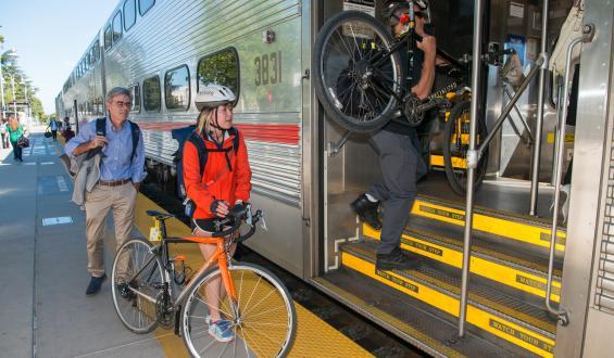 Woman boarding Caltrain with bike